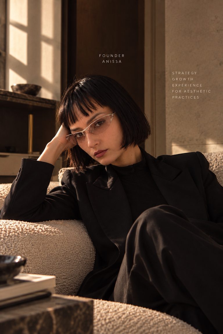 Anissa Sabrina Briki, founder of Kinassay Lab, seated on a cream sofa: editorial portrait captioned “Founder, Anissa”